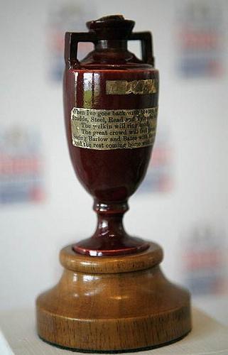 A small, brown terracotta urn